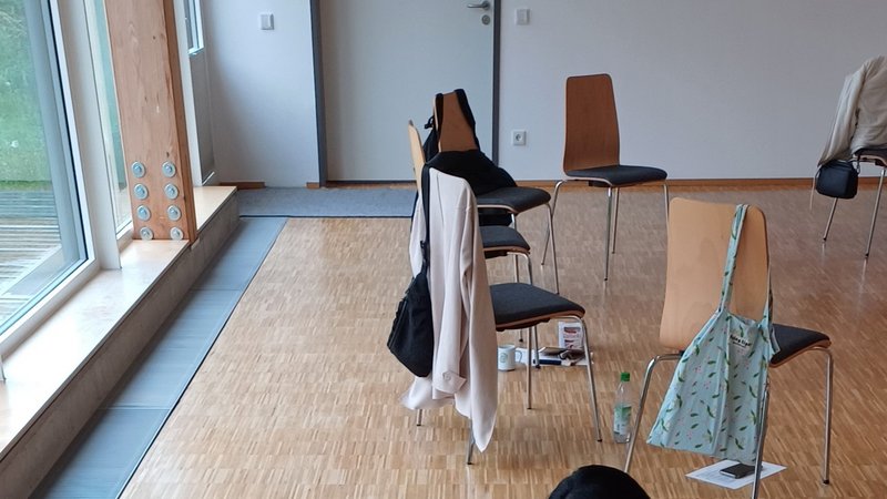 Drei Menschen sitzen auf dem Boden und gestalten ein Poster